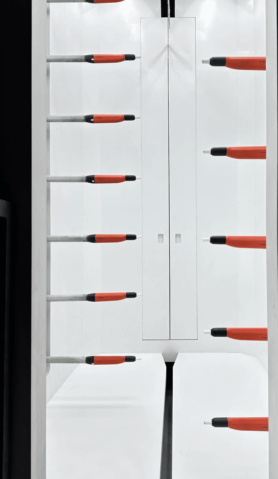 Rows of Electron automatic powder coating guns mounted in a spray booth