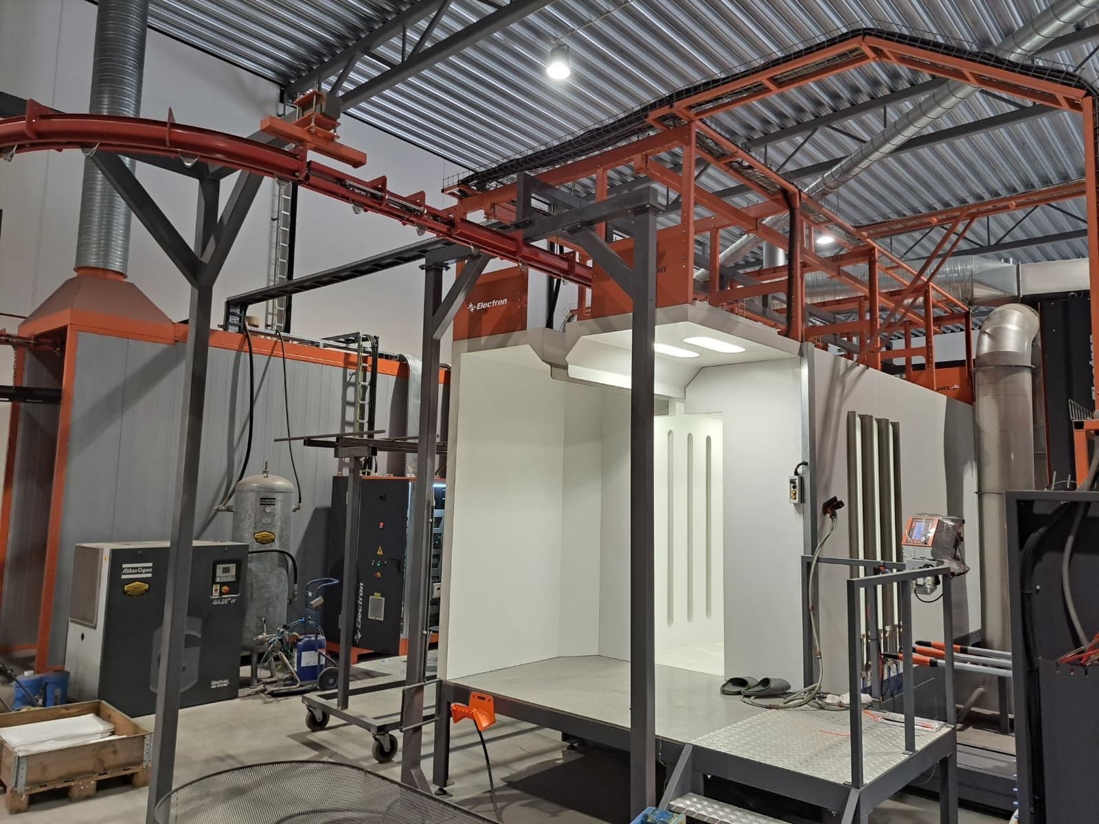 Installed Electron powder coating booth with overhead conveyor rail and cyclone powder recovery