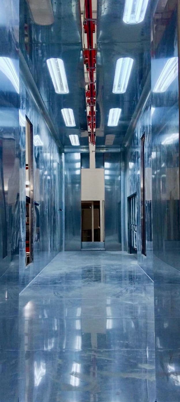 Interior corridor of a mirror-finish stainless steel powder coating booth